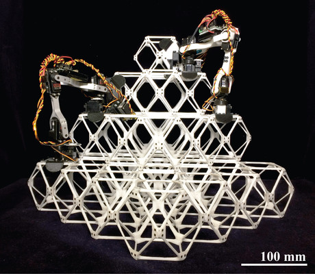 Assembler robots make large structures from little pieces Assembler robots make large structures from little pieces