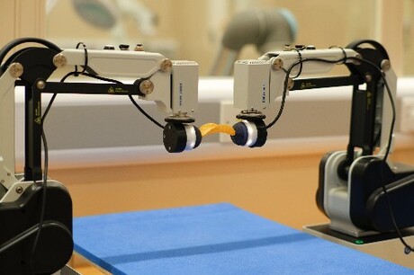 Dual-arm robot achieves bimanual tasks by learning from simulation Dual-arm robot achieves bimanual tasks by learning from simulation